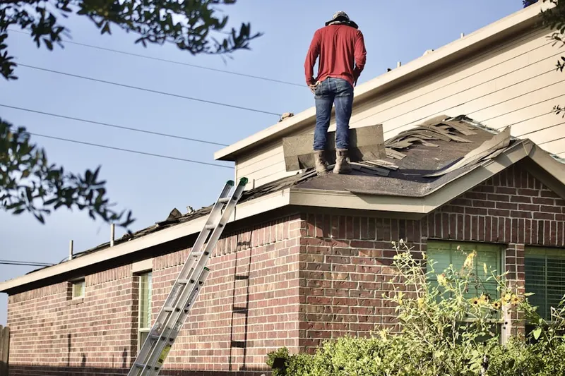 Professional roofer working on a residential roof in Five Corners